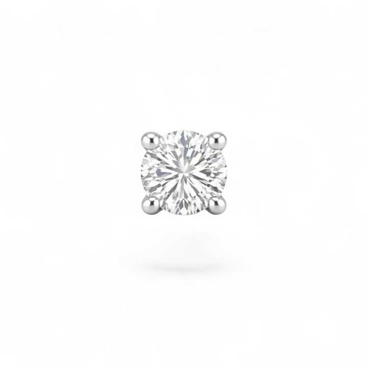 Single diamond earring on a white background