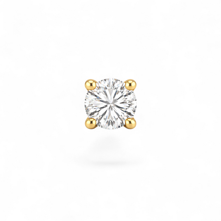 Single diamond earring with gold prongs on a white background