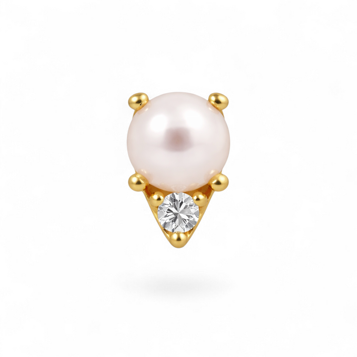 Single pearl earring with gold setting and clear gemstone on a white background