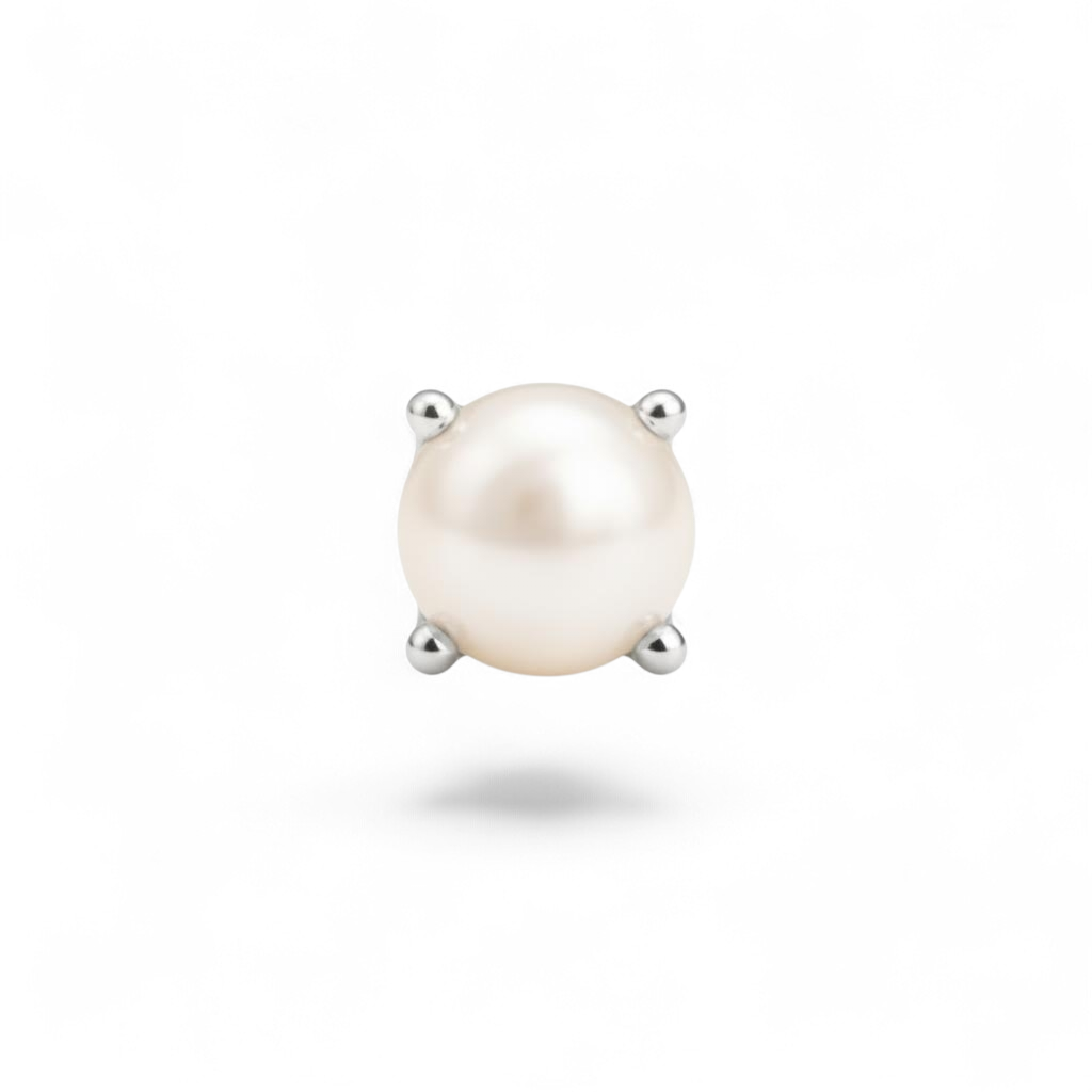 Single pearl earring with silver prongs on a white background