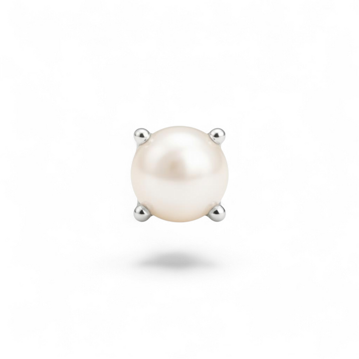 Single pearl earring with silver prongs on a white background