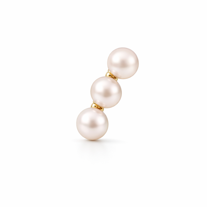 Three pearl bar earring with gold setting on a white background